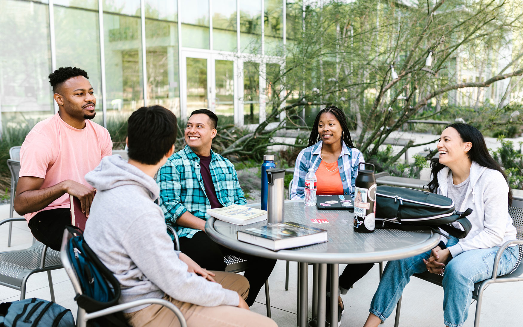 group of people sit around table talking