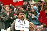 Photo of a child at a demonstration to support refugees