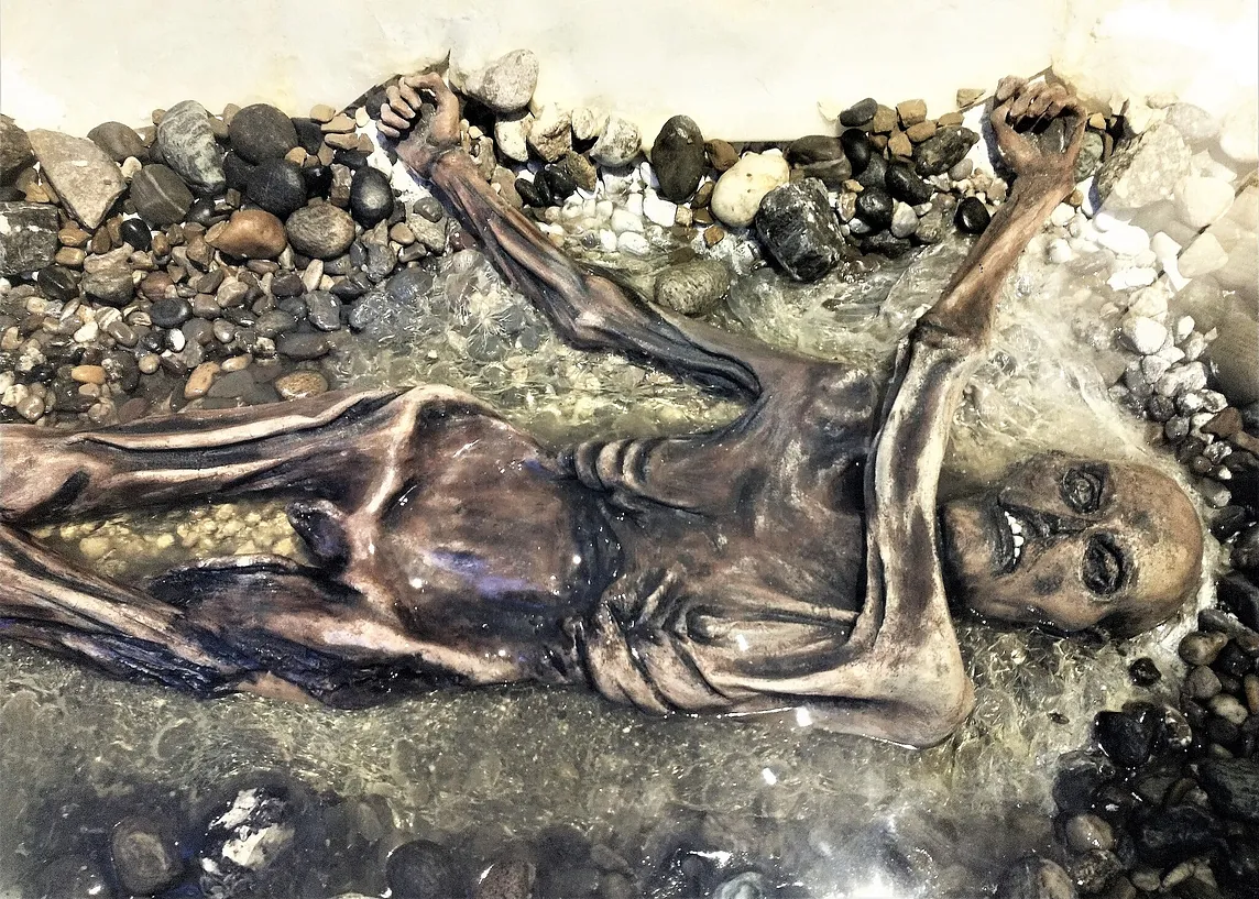 mummified remains of Otzi, free of ice, on bedrock and gravel