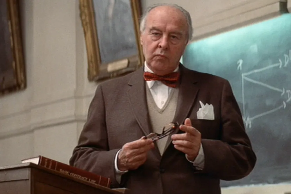 A photo of actor John Houseman standing in a classroom playing Professor Charles Kingsfield in the movie The Paper Chase.