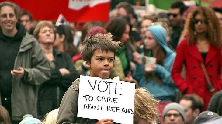 Photo of a child at a demonstration to support refugees