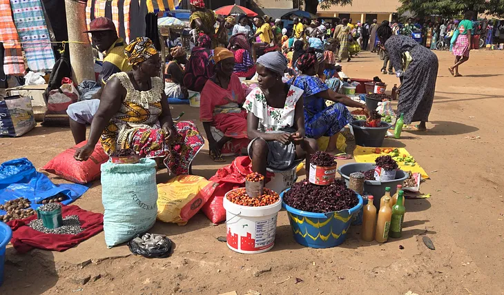 Women selling food products in an open street market