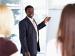 Man standing by easel in front of audience