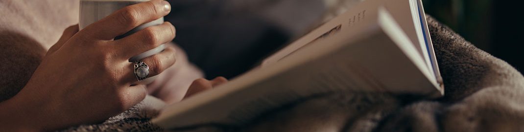 Person sitting on a couch reading