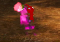 A Red Pikmin jumping up and down under the confusion status effect.