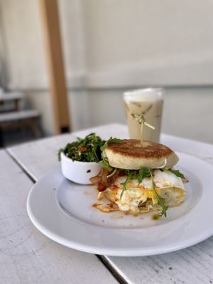 Photo of The Grove Cafe & Market - Albuquerque, NM, US. Breakfast sandwich ($11) with iced coffee