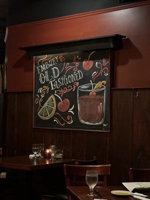 Photo of The Redwood Room - Rochester, MN, US. a chalkboard with a drink and a sign