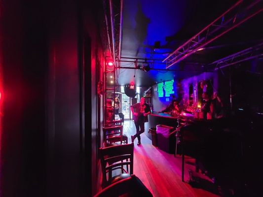 Photo of See-Scape - Toronto, ON, CA. a man walking through a dimly lit bar