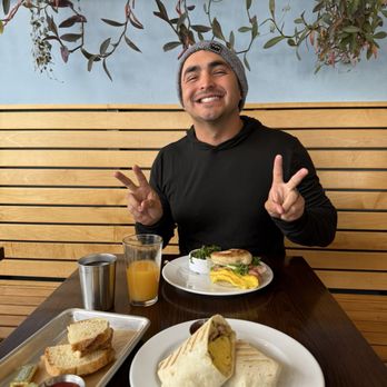 Breakfast burrito, breakfast sandwich, sourdough bread and fresh squeezed OJ