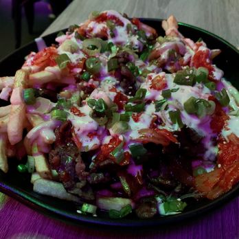 Bulgogi Fries - French Fries Topped with Bulgogi, Kimchi, Garlic Mayo, Kimchi Mayo, Green Onions, and Sesame Seeds