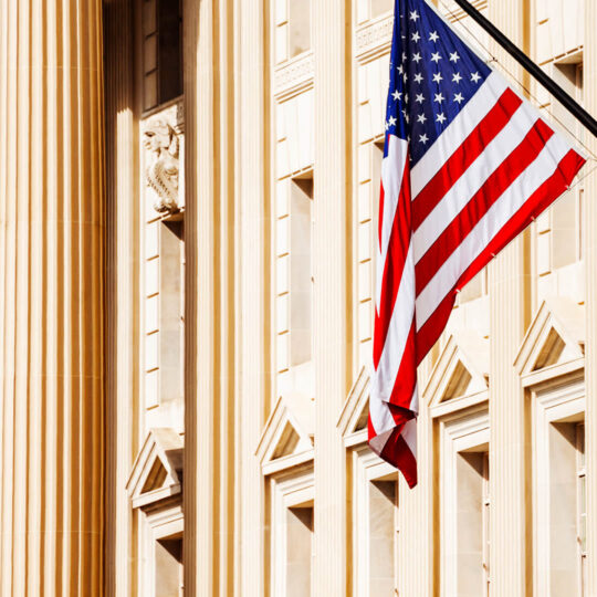 American flag against buildings