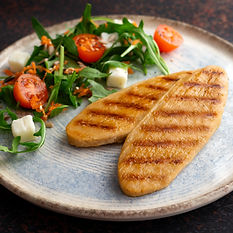 plant based chicken fillets on a plate with side salad healthy and nutritious vegan food