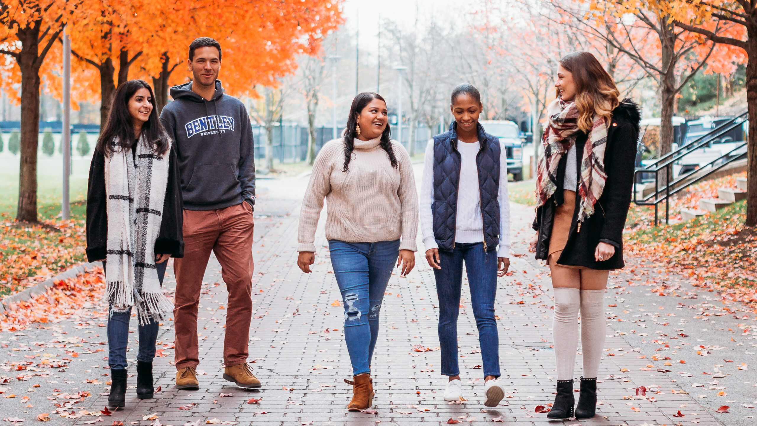 students walking on campus in the fall at Bentley University