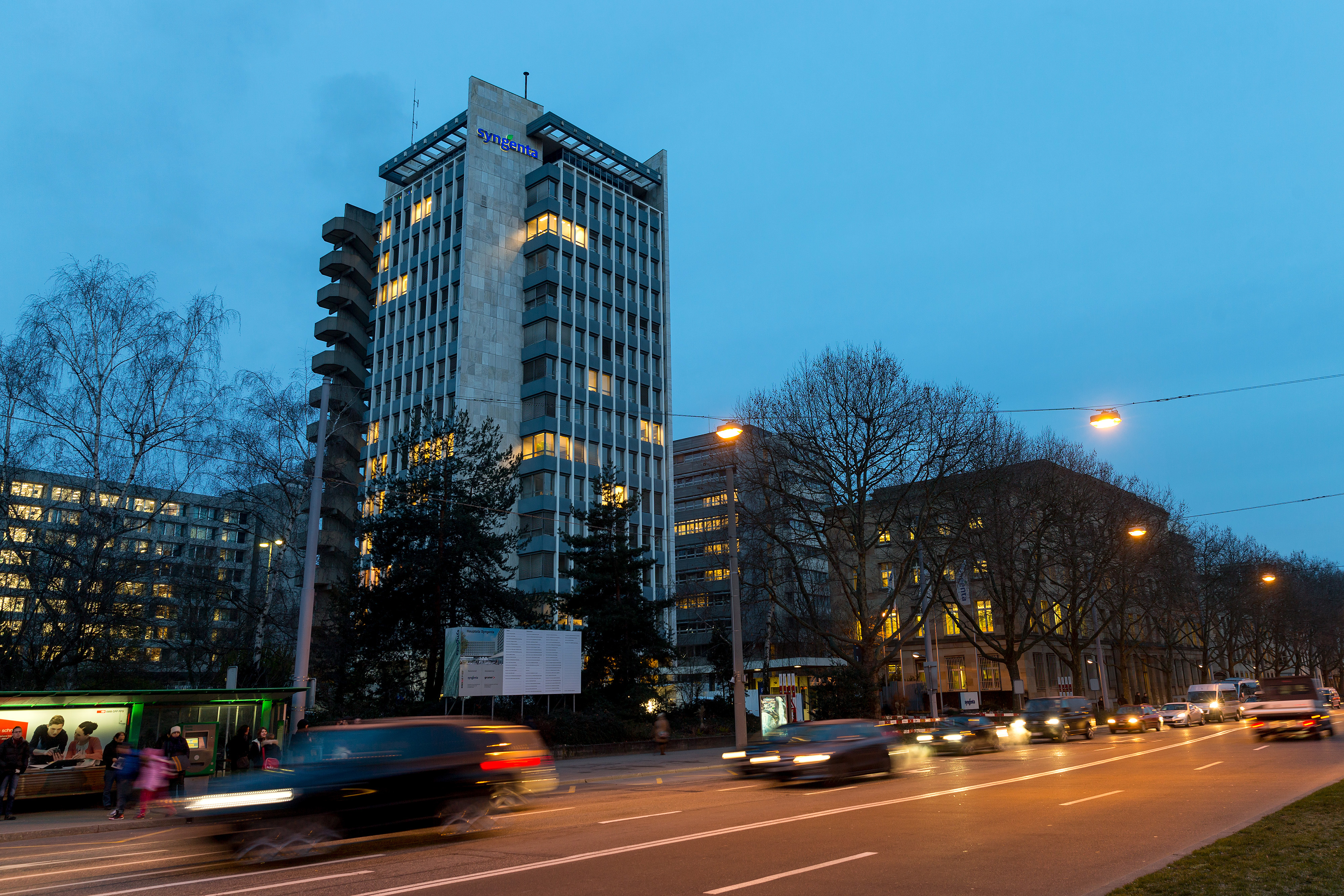 Automobiles pass Syngenta AG's headquarters at dawn in Basel, Switzerland, on Feb. 4, 2015. Syngenta, the world's largest maker of crop protection chemicals, forecast stable earnings this year as the benefits of a cost-cutting program offset unfavorable currency shifts. Photographer: Philipp Schmidli/Bloomberg via Getty Images