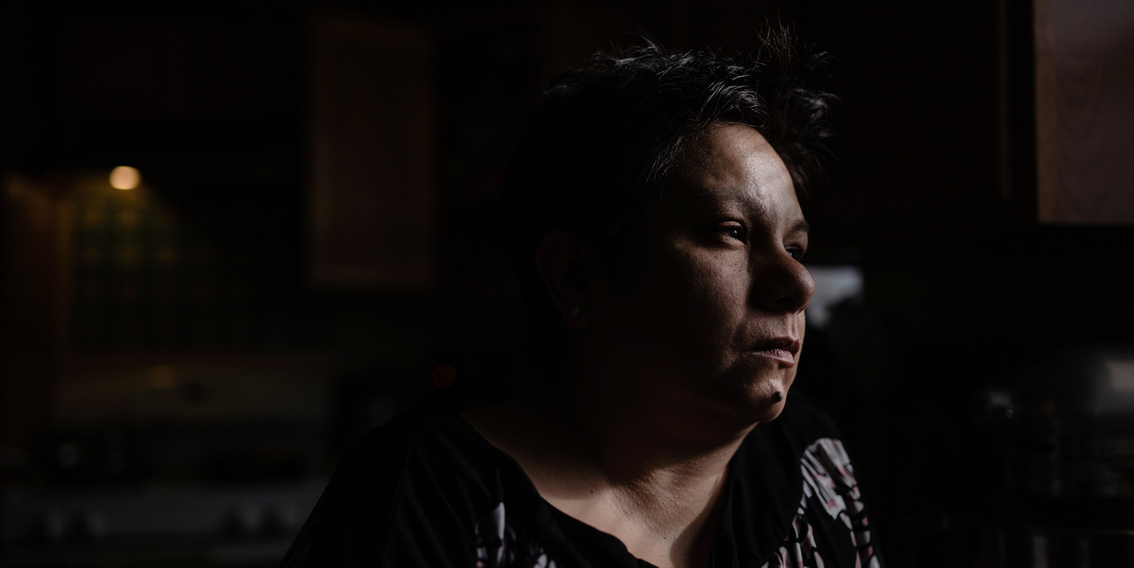 Angela Ramirez looks out the window of her home in Waukegan, Ill. on Jan. 2, 2020. Ramirez, who was diagnosed with breast cancer, lives less than six miles away from two factories that emit ethylene oxide, a gas known to cause cancer. Pat Nabong for The Intercept.