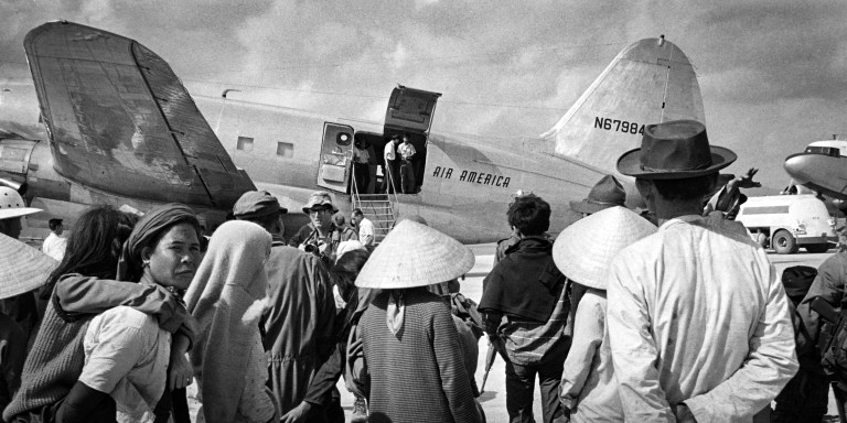 Refugees board on the Air America plane, on January 23, 1968 in Da-Nang, fleeing the battle of Khe Sanh during the Vietnam war. (Photo by Francois MAZURE / AFP) (Photo by FRANCOIS MAZURE/AFP via Getty Images)