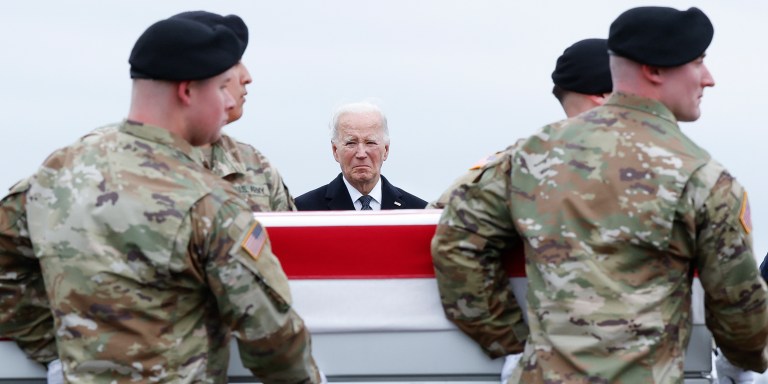 DOVER, DELAWARE - FEBRUARY 02: U.S. President Joe Biden places his hand over his heart while watching a U.S. Army carry team move a flagged draped transfer case containing the remains of Army Sgt. William Rivers during a dignified transfer at Dover Air Force Base on February 02, 2024 in Dover, Delaware. U.S. Army Sgt. William Rivers, Sgt. Breonna Moffett, and Sgt. Kennedy Sanders was killed in addition to 40 other troops who were injured during a drone strike in Jordan. (Photo by Kevin Dietsch/Getty Images)