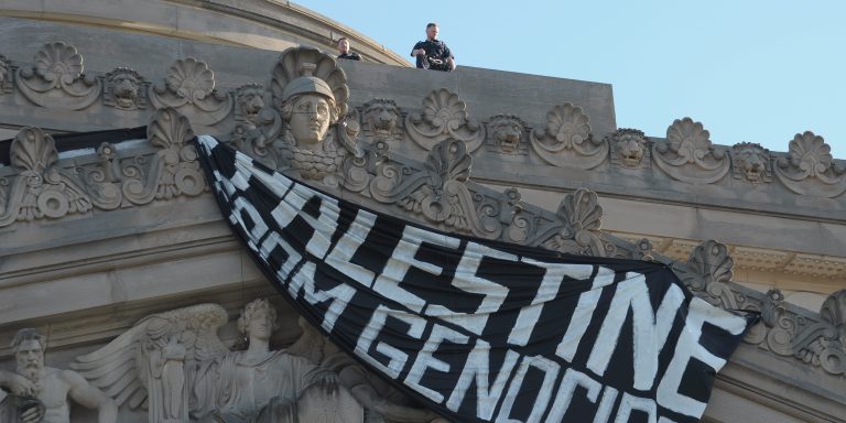 The New York City Police Department officer stands on the roof of the Brooklyn Museum where pro-Palestine demonstrators dropped a banner earlier. Pro-Palestine demonstrators rallied in Brooklyn, New York City condemning the Israel Defense Forces' military operations in Gaza. The march took place following IDF military operations in Rafah in southern Gaza. Earlier this week, an IDF strike and resulting fire at a refugee camp in Rafah killed dozens of people. On Friday, the IDF said its forces are conducting operations in central Rafah. Since the Israel-Hamas war started on October 7, 2023, Gaza's health ministry said more than 36,000 people have been killed in Gaza, a territory ruled by Hamas. The death toll does not differentiate between civilians and combatants. (Photo by Jimin Kim / SOPA Images/Sipa USA)(Sipa via AP Images)