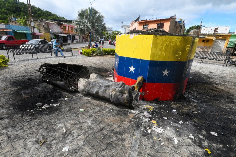 A statue of the late Venezuelan President Hugo Chavez is destroyed in Valencia, Venezuela, Tuesday, July 31, 2024, the day after protests against the official election results that certified Chavez's protege, current President Nicolas Maduro, as the winner.