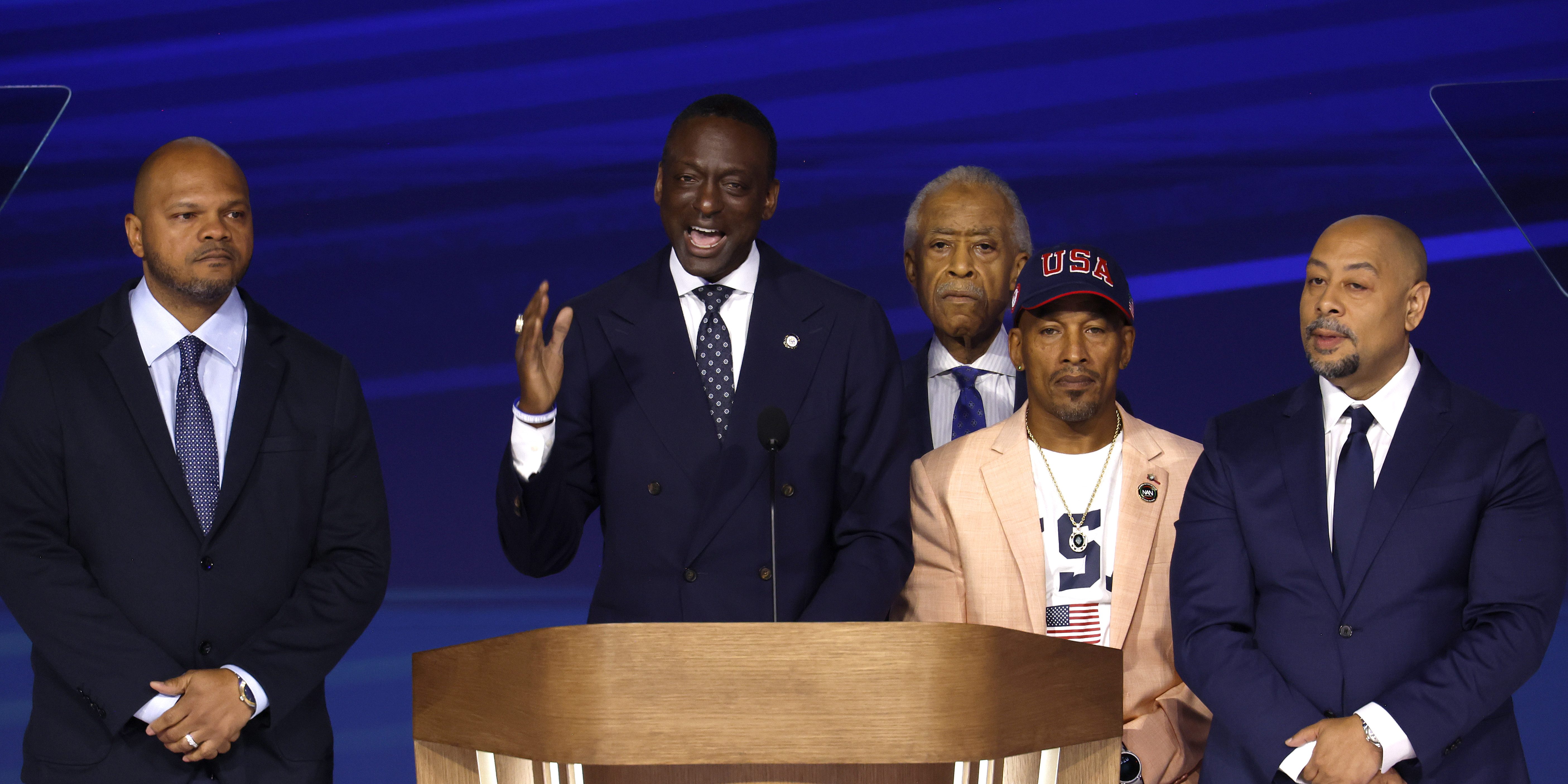 CHICAGO, ILLINOIS - AUGUST 22: Representatives from “the Central Park Five,” New York City Council Member Dr. Yusef Salaam (2nd-L) speaks on stage as (L-R) Activist Kevin Richardson, Rev. Al Sharpton, Activist Korey Wise, and Activist Raymond Santana look on during the final day of the Democratic National Convention at the United Center on August 22, 2024 in Chicago, Illinois. Delegates, politicians, and Democratic Party supporters are gathering in Chicago, as current Vice President Kamala Harris is named her party's presidential nominee. The DNC takes place from August 19-22. (Photo by Chip Somodevilla/Getty Images)