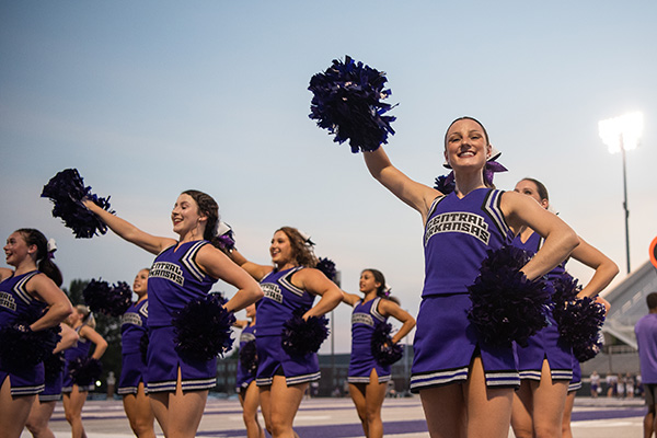 Cheerleaders cheering at football game