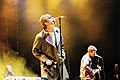 Oasis brothers Noel and Liam Gallagher performing in 2005