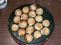 An electric homemade takoyakiki frying takoyaki pieces