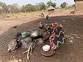 File:A woman frying Shea nuts.jpg