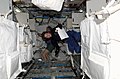 Astronauts Wendy B. Lawrence (foreground) and Andrew S. W. Thomas inside Raffaello module