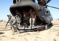 U.S. Army soldiers of the 101st Airborne Division’s Company C, 3rd Battalion, 187th Infantry Regiment, exit an Army CH-47 Chinook helicopter at Brassfield-Mora, Iraq, March 16, 2006, in support of Operation Swarmer.