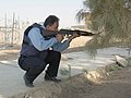 Iraqi Policeman aiming with an AKM