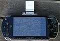 A PlayStation Portable with OpenStreetMap data on screen.