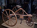 Three spoked wheels on an antique tricycle