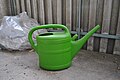 green plastic watering can