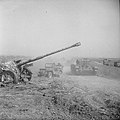 A Cromwell tank and jeep pass an abandoned German PAK 43/41 gun during Operation 'Totalize', 8 August 1944.