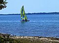 Sail boat on the water of drying Bracciano lake, Italy