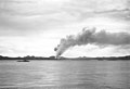 Smoke rises from Tulagi after bombing by U.S. carrier aircraft on 7 August 1942, the day U.S. Marines landed to capture the island. The destroyer at left is either USS Ellet (DD-398) or USS Wilson (DD-408).