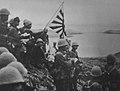 Japanese troops raise the Imperial battle flag on Kiska Island in the Aleutians on June 6, 1942.