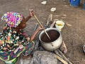 File:A woman frying shea nuts.jpg