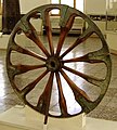 A spoked wheel on display at The National Museum of Iran, in Tehran. The wheel is dated to the late 2nd millennium BCE and was excavated at Choqa Zanbil