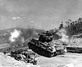 M4A3E8 Sherman tank fires its 76mm gun at enemy bunkers on "Napalm Ridge", in support of the 8th ROK Division, Korea, 11 May 1952.