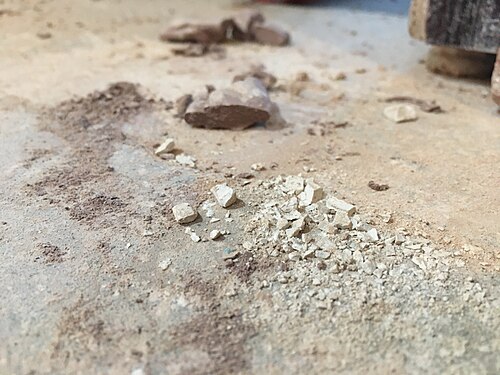 Different size grains of clay dust on the floor of a ceramics studio