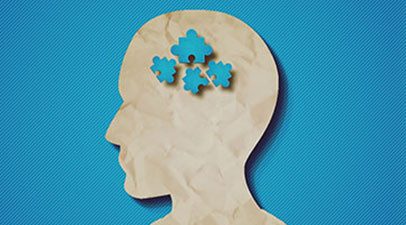 Crumpled paper in the shape of a man's profile on a blue background. Four blue puzzle pieces are overlayed where his brain would be.