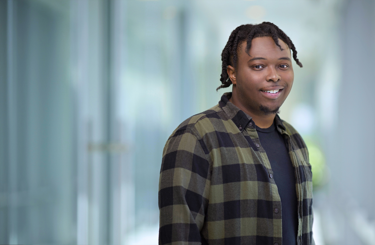 Quincy, standing, smiling into the camera