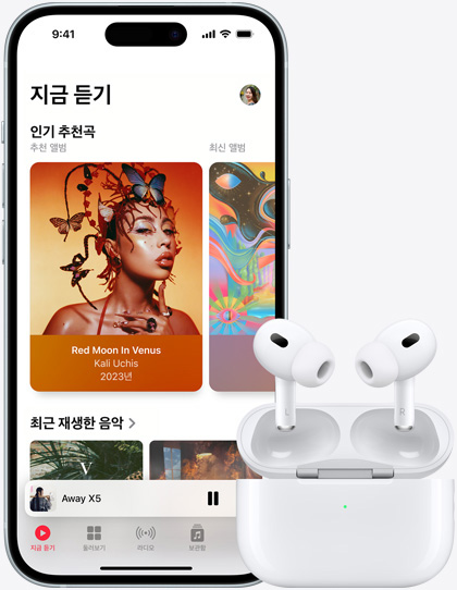 음악이 재생되고 있는 iPhone 15 옆에 AirPods이 놓여 있는 모습