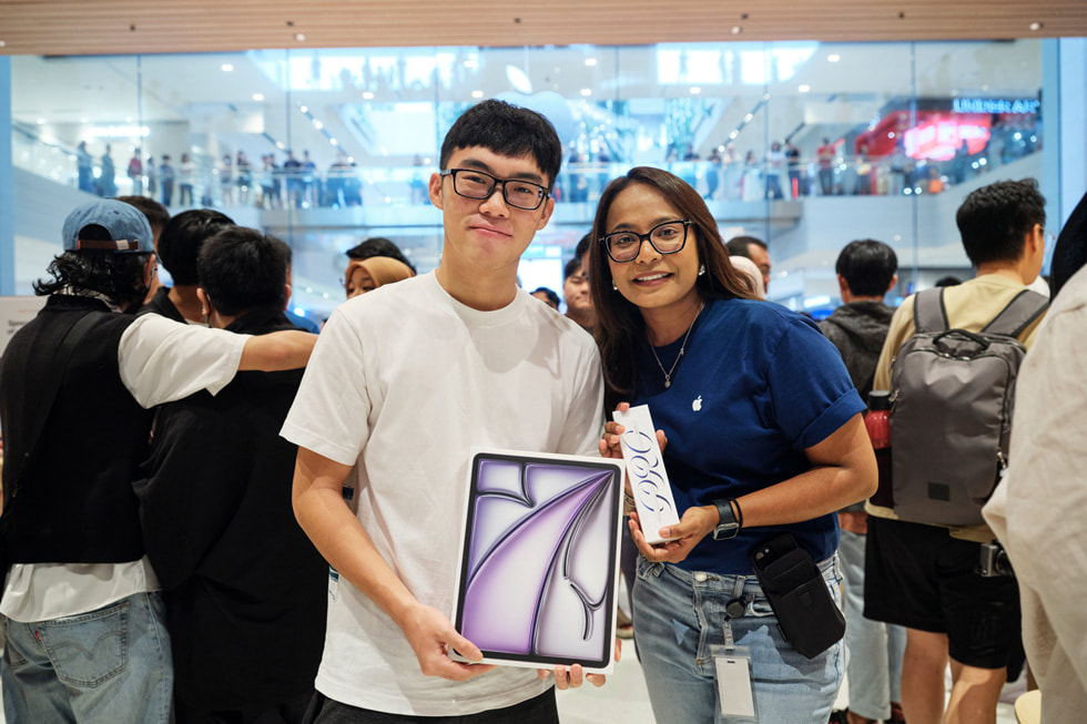 A customer with an Apple team member showing off his iPad Air and Apple Pencil Pro purchase.