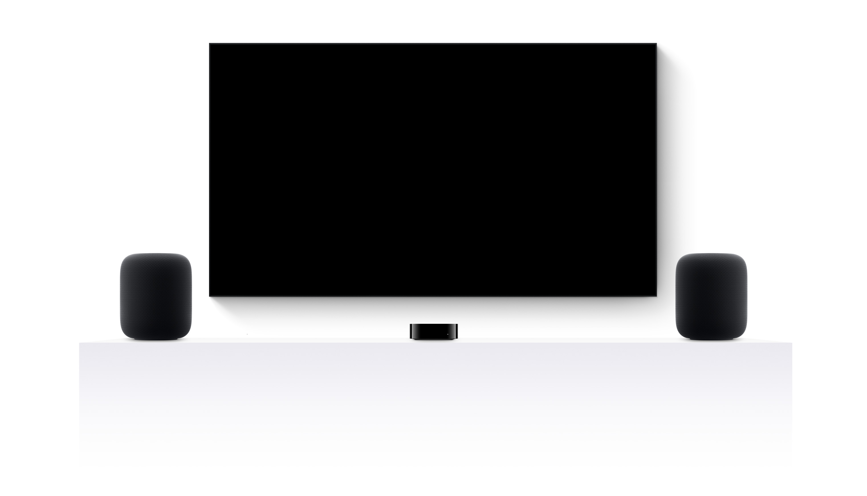 Apple TV 4k, two HomePods, and a flatscreen television showing an edited trailer of various Apple TV  movies and shows