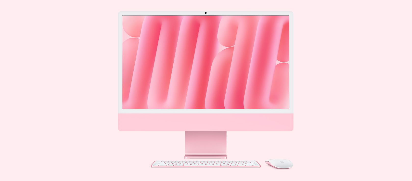 Tampilan depan iMac pink dengan mouse dan papan ketik berwarna senada