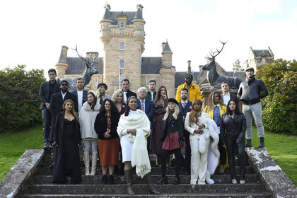 The Cast of The Traitors Season 2 in front of a castle.