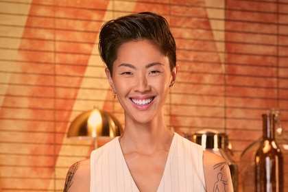 Kristen Kish wearing a vest in a kitch pantry